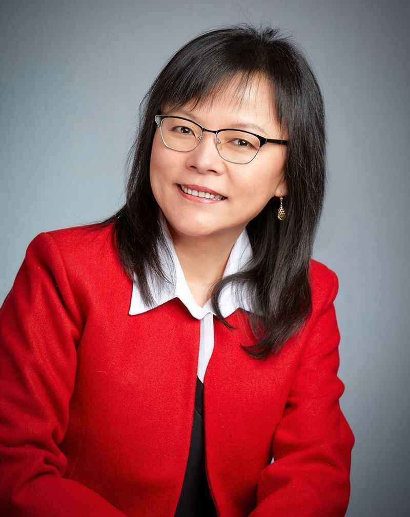 Hong Wang wearing red polo with eye glasses picture